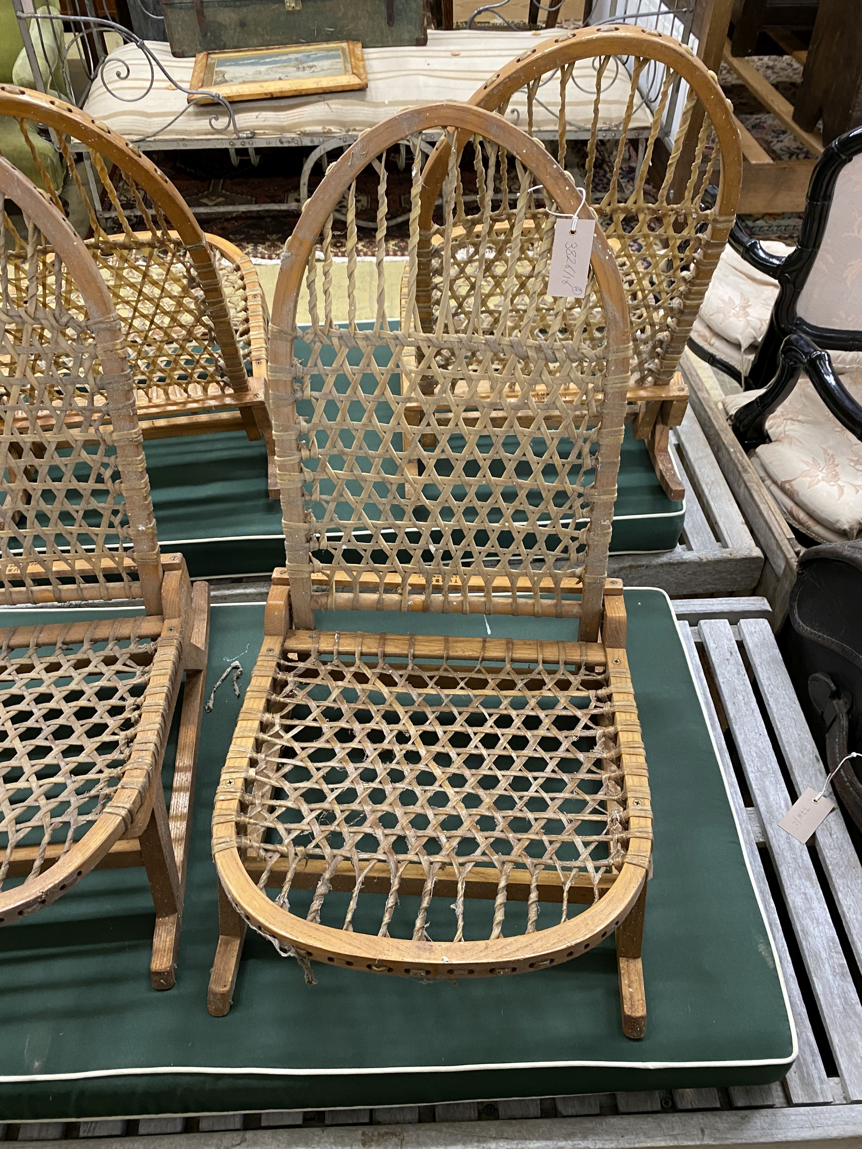 A set of four vintage American bentwood and animal gut folding canoe seats by Tubbs of Wallingford, width 40cm, depth 52cm, height 60cm